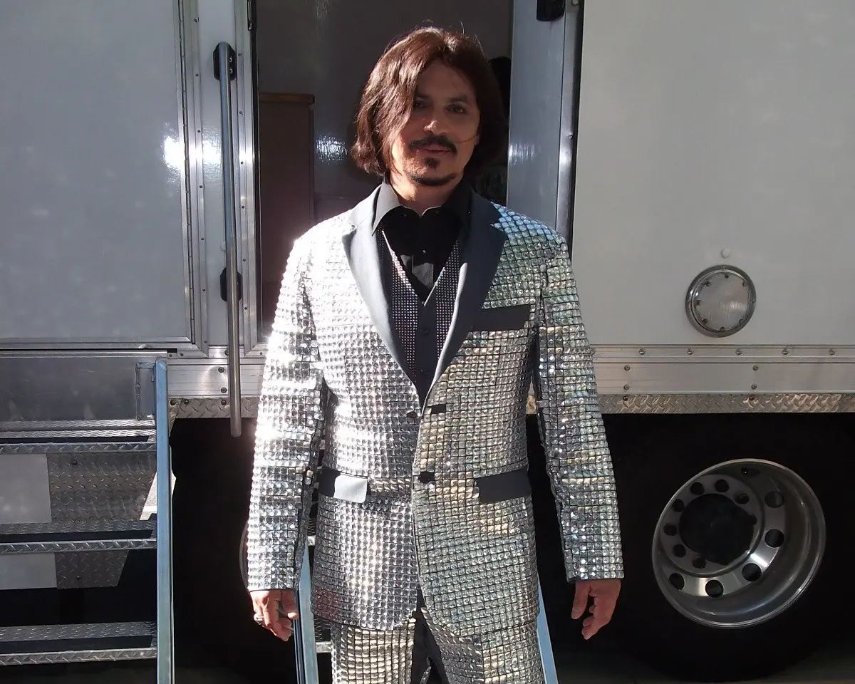 A person wearing a shiny suit