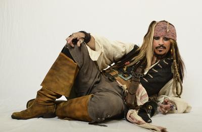 A person sitting on the floor wearing a costume from Pirates of the Caribbean