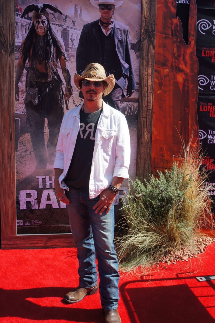 A person standing and wearing a cowboy hat